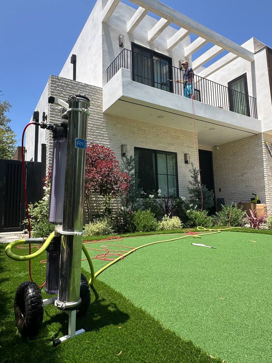 LA Window Washers technician cleaning upper-story windows with a deionized water system