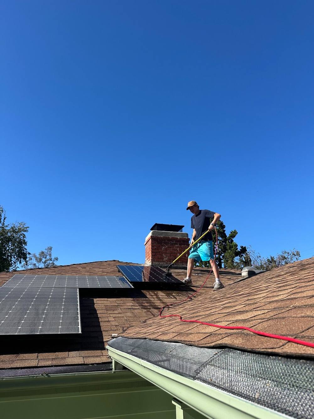 LA Window Washers technician cleaning rooftop solar panels
